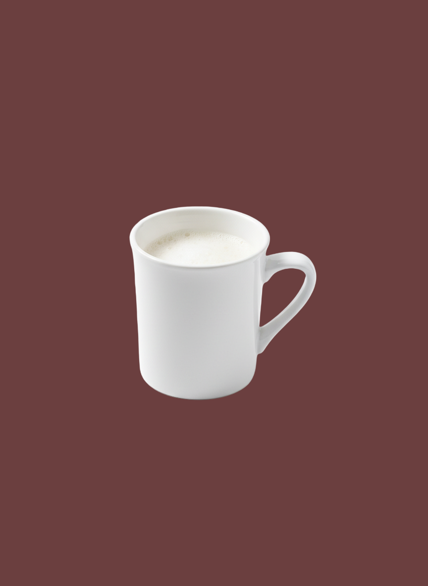 White mug with a creamy beverage on a brown background