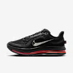 Black athletic shoe with red accents on a white background